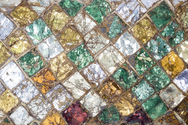 A mosaic of green and yellow glass tiles.