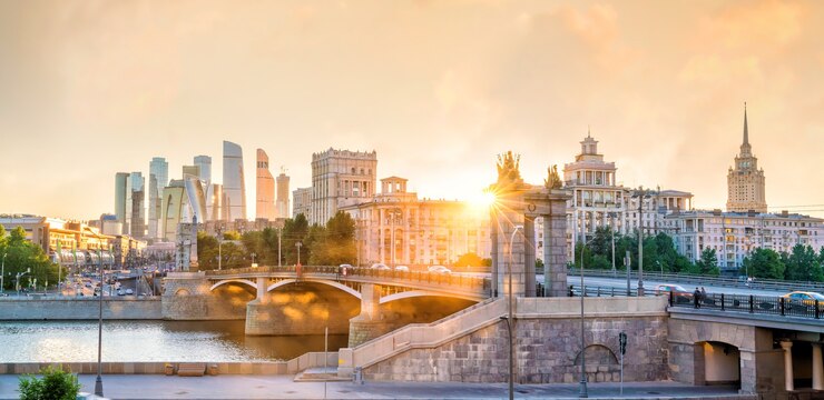 Деловой район горизонта города Москвы и Москва-река в России на закате