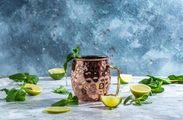 Moscow mule alcoholische cocktail in koperen mok met limoen, gemberbier wodka en munt