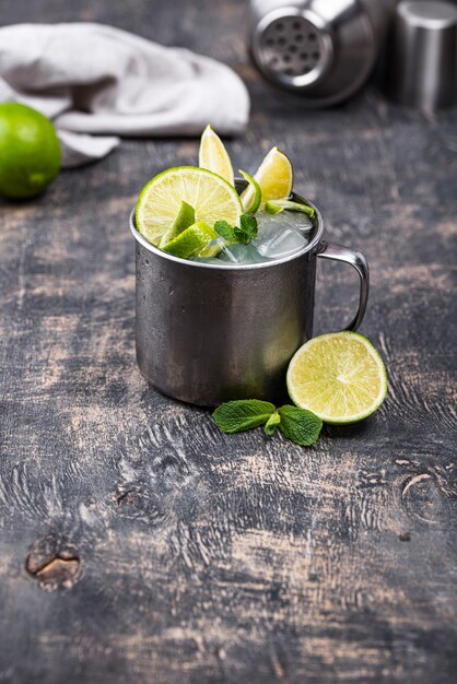 Moscow mule cocktail in mug with lime and mint