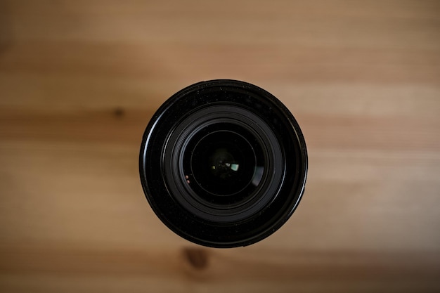 MOSCOW RUSSIA 17 MARCH 2019 Fuji LENS the camera lens on light wooden table Top view Flat lay style Close up