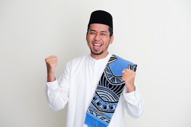 Moslem Asian man showing excited expression with both fist clenched