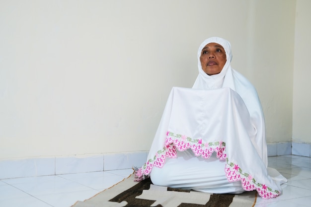 Moslem woman praying in her house