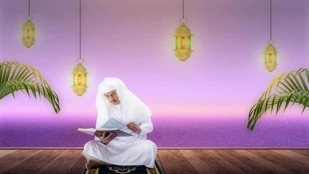 Moslim man zit en leest de koran op het gebedskleed