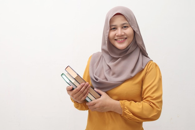 moslim zakenvrouw met een boek glimlachend educatieve of vrijetijdsactiviteit concept geïsoleerd op wit