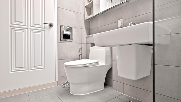 The most common bathroom layout is a toilet sink and shower area with a glass partition