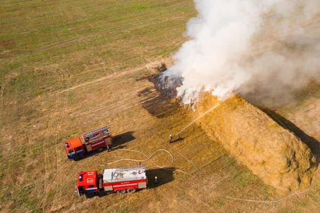 MOSTY BELARUS september 2020 Fire engines extinguish straw top view