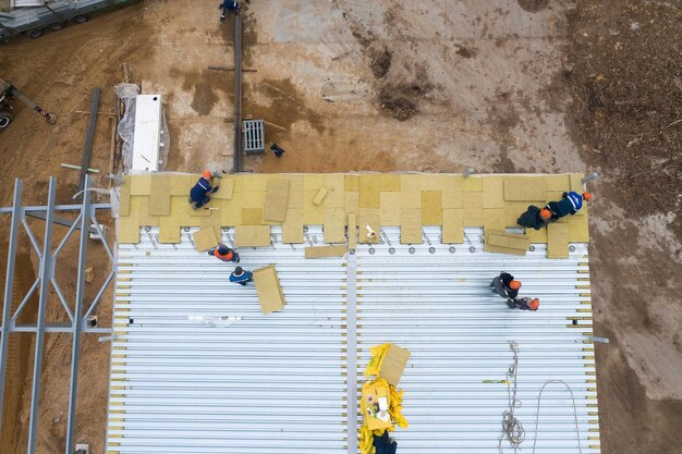 Mosty belarus september 2020 workers install insulation on the\
roof top view