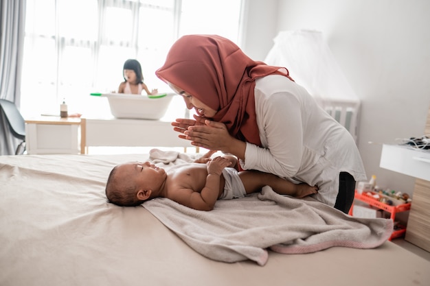 Mother applying oil to her baby