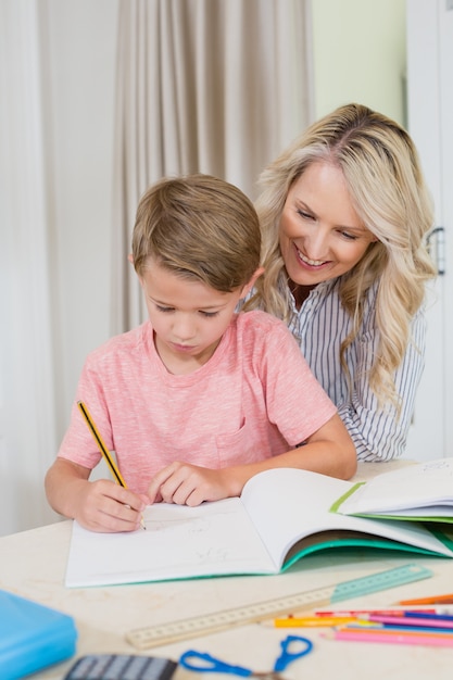 Mother assisting son doing homework