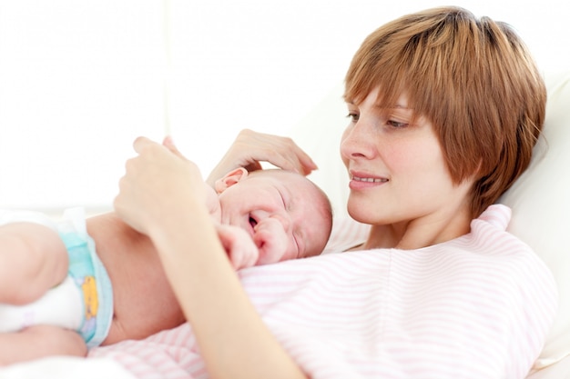 Mother attending to her newborn baby