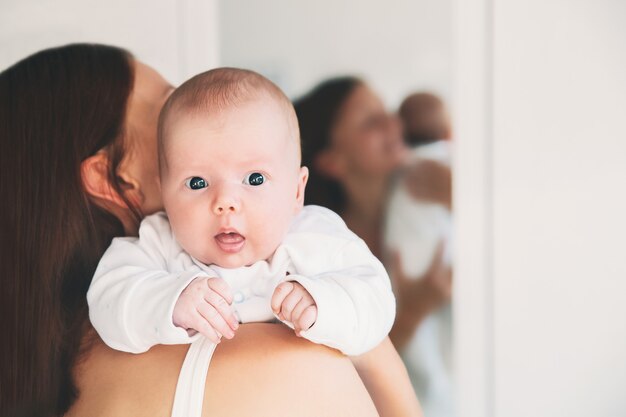 Mother and Baby Beautiful woman holding a baby child in her arms appy maternity and family