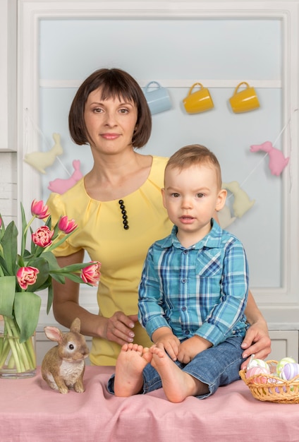 Mother and baby in the Easter decorated pastel kitchen.