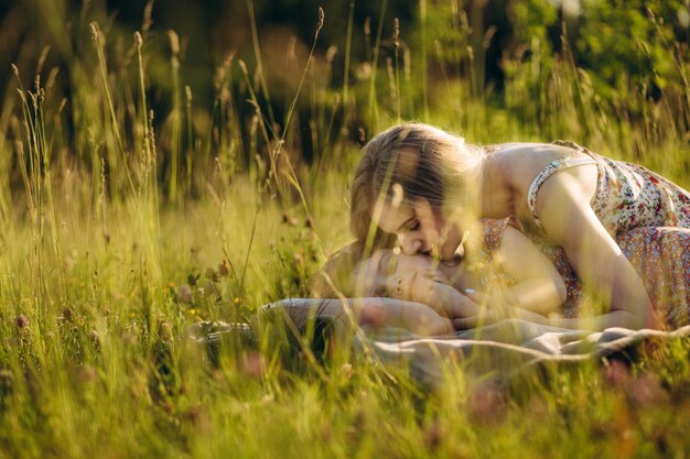 Mother and baby girl sitting and relaxing in park