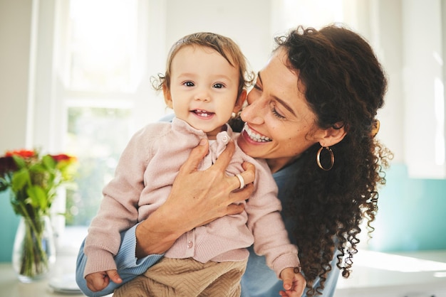 Mother baby and happiness portrait with a hug in a family home while together for love support and care Woman or mom and girl child with a smile on face for quality time bonding and to relax