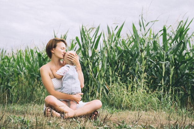 Mother and baby outdoors Family on nature Loving woman with child in countryside Photo of natural parenthood maternity leave Theme of zero waste slow fashion and conscious life eco lifestyle