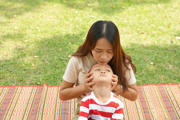 Mother and baby playing in the park happily