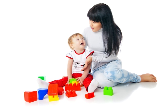 Mother and baby playing with building blocks toy