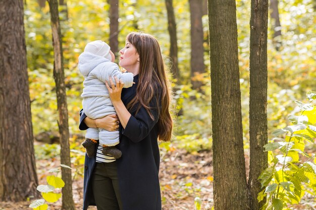 Mother and baby relaxing in the autumn park