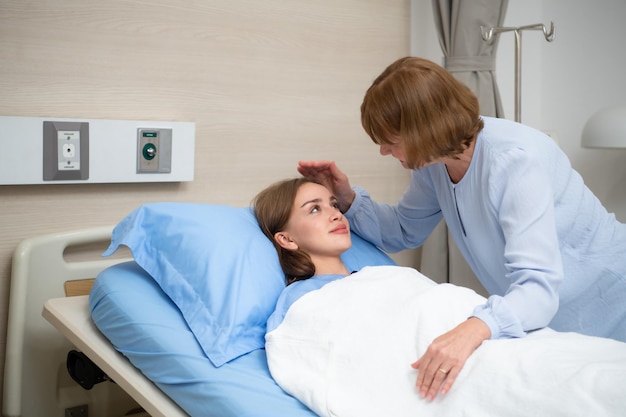 A mother blankets her child who is hospitalized Show your love and concern with a kiss