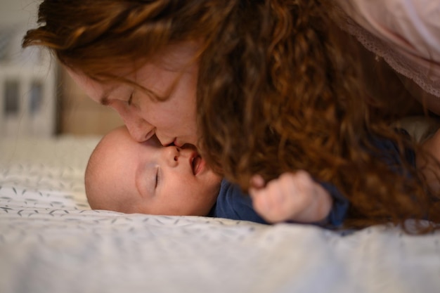 Mother bonding with her baby and kissing his tiny nose