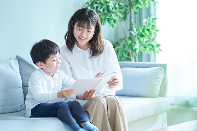 Mother and boy sitting and reading picture book