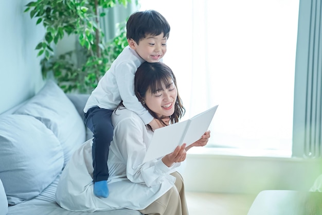 Mother and boy sitting and reading picture book