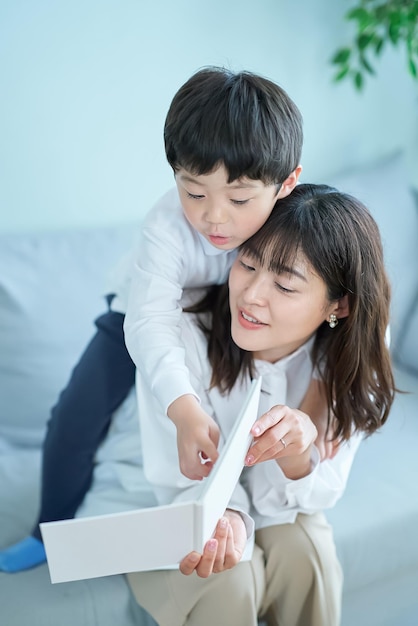 Mother and boy sitting and reading picture book