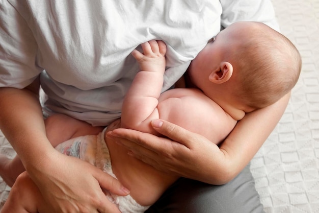 Photo mother breastfeeding baby at home mom nursing infant nurturing portrait of child suckling milk from breast authentic shot of mother is breastfeeding her newborn baby close up concept of maternity