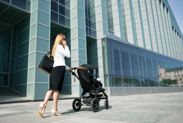 Mother in business world with baby carriage