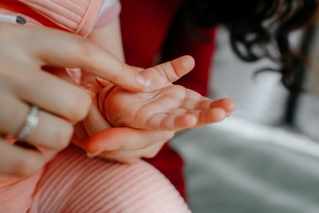 mother caressing the little cute hand of her daughter