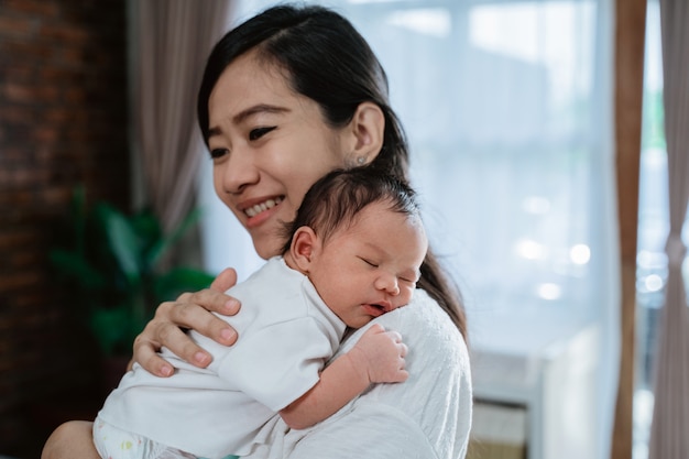 Mother carrying adorable little daughter