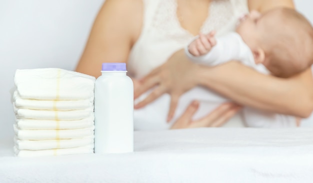 Photo mother changes baby's diaper