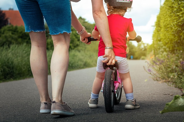 A mother and child on a bike with a child on the back