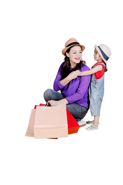 Mother and child carrying shopping bags on studio