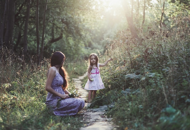 Mother and child daughter in nature park