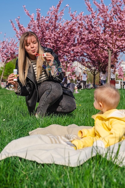 Mother and child enjoy the cherry blossom season with bubble play