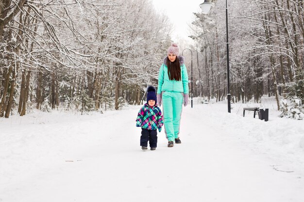 Mother and child enjoying beautiful winter day outdoors.