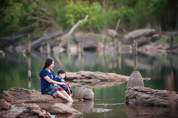 Mother and child fishing at the river