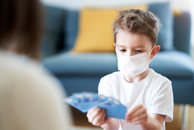 mother and child playing together at home isolation during coronavirus pandemic