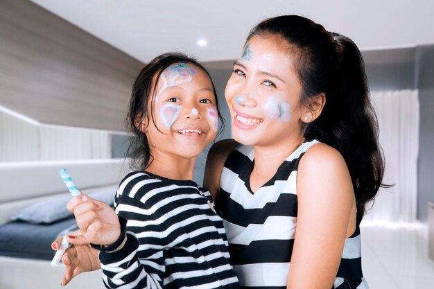 Mother and child playing with face painting