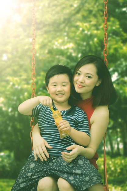 Mother and child sitting on the swing