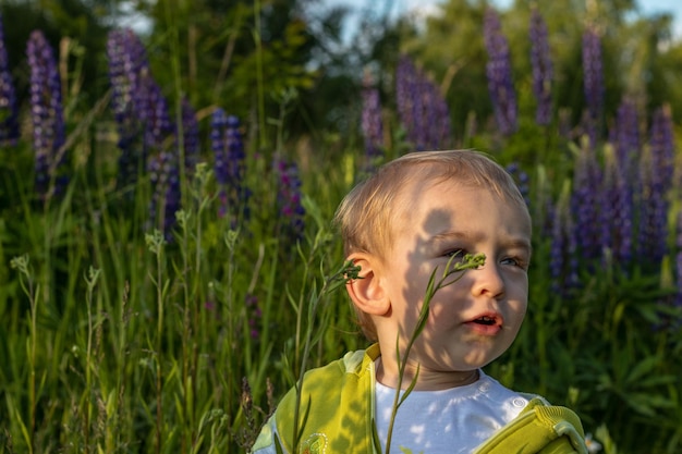 mother and child son are walking in a field of flowers