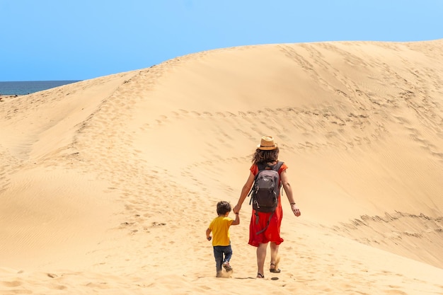 Mother and child on vacation in the dunes of Maspalomas Gran Canaria Canary Islands