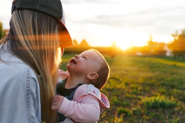 Mother and child walk in the park in the evening