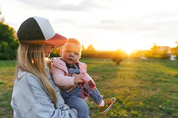 Mother and child walk in the park in the evening