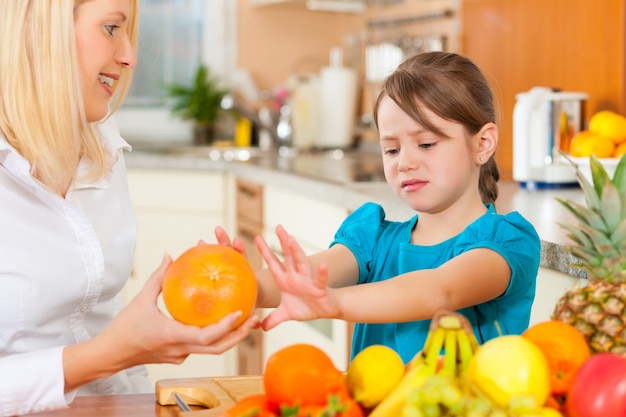 Mother and child with lots of fruits