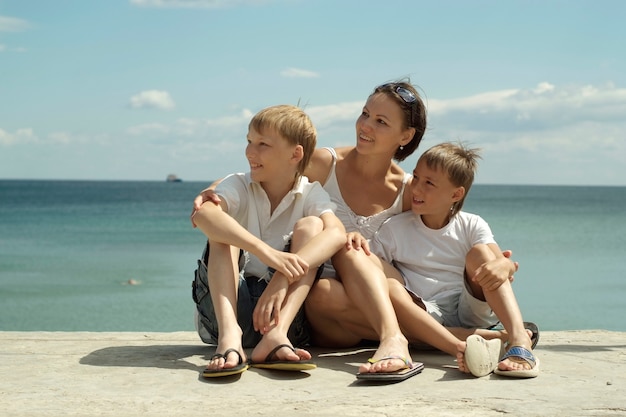 Mother and children on the background of the sea