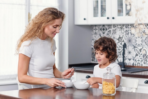 Mother and children having breakfast at home