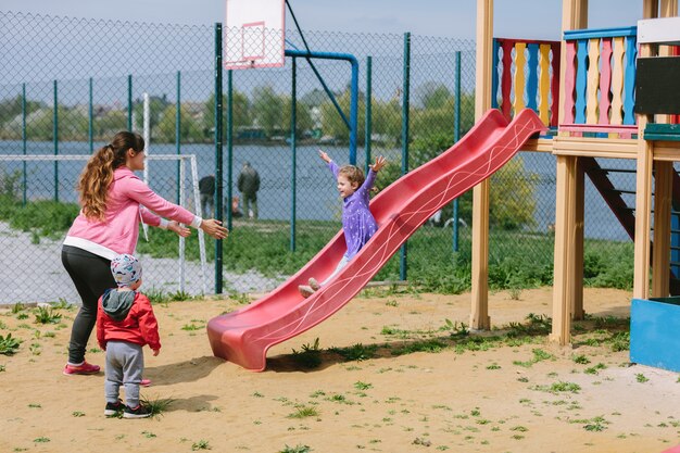 Mother and children playing on a playground